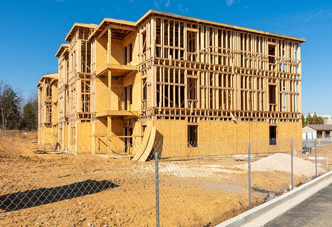 a temporary chain link fence locking away a building under renovation, serving as a security tool in Lindenhurst, IL